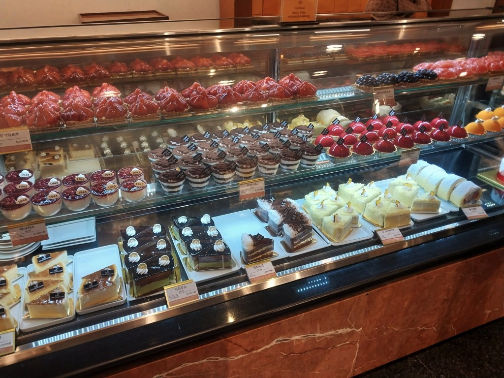 Tarts and puddings in a glass case